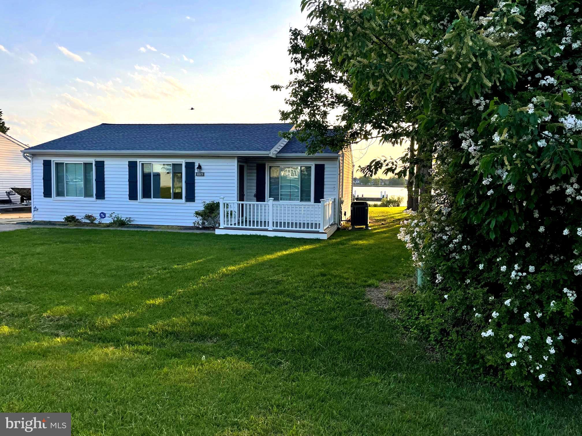 a front view of house with yard and trees