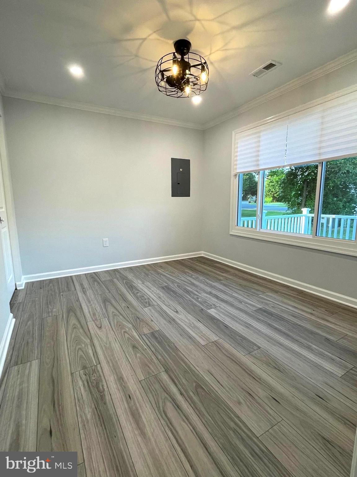 1819 Sherman Drive Chester, MD 21619 - Photo 5 of 36 an empty room with wooden floor and windows
