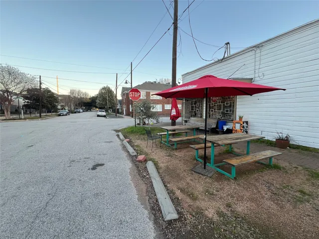 a view of the patio with a table and chairs under an umbrella