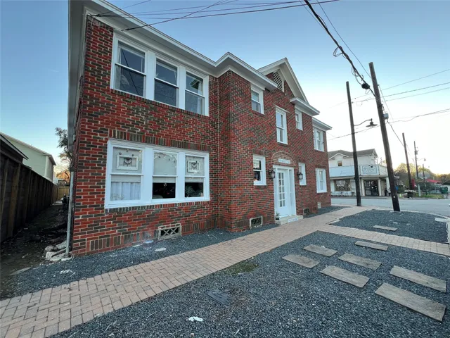 a view of a brick house with many windows