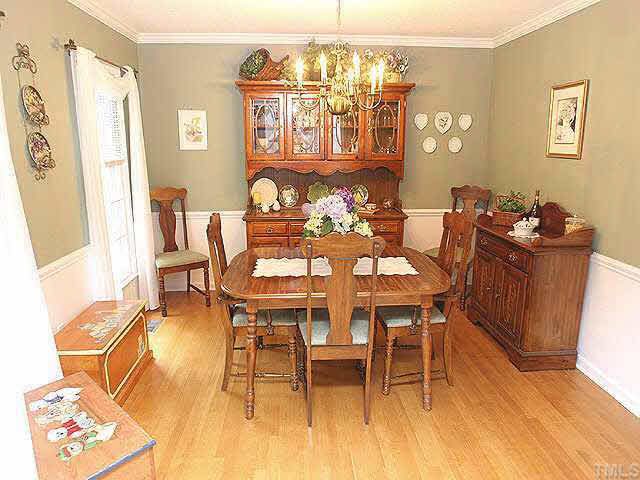 3012 Oxbow Court Raleigh, NC 27613 - Photo 3 of 9 a dining room with furniture and wooden floor