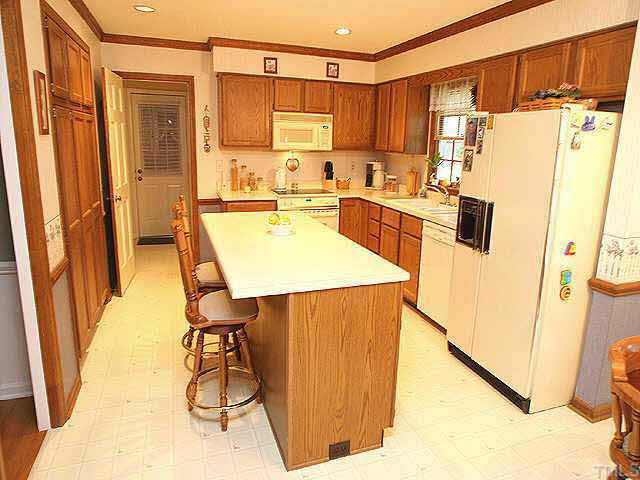 3012 Oxbow Court Raleigh, NC 27613 - Photo 4 of 9 a kitchen with stainless steel appliances a refrigerator a sink a stove and white cabinets