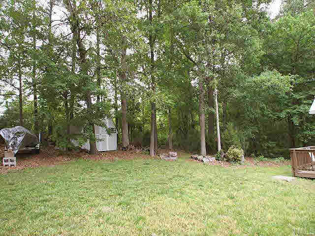 3012 Oxbow Court Raleigh, NC 27613 - Photo 8 of 9 a backyard of a house with lots of green space