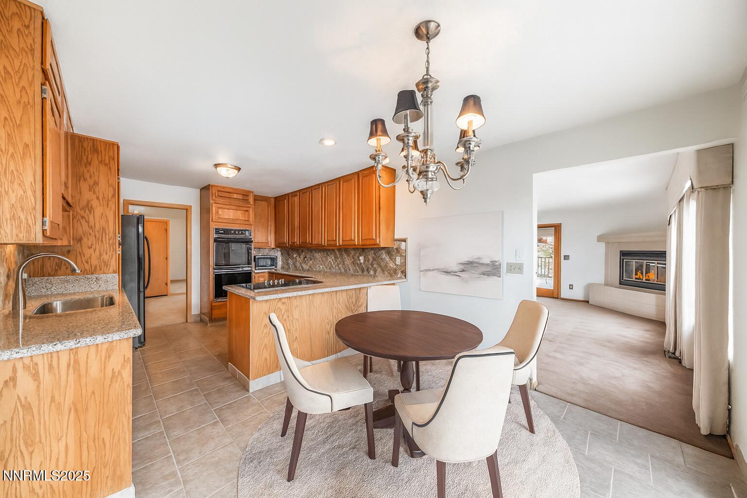 2220 Stone Mountain Circle Reno, NV 89519 - Photo 18 of 58 a dining room filled chandelier and kitchen view