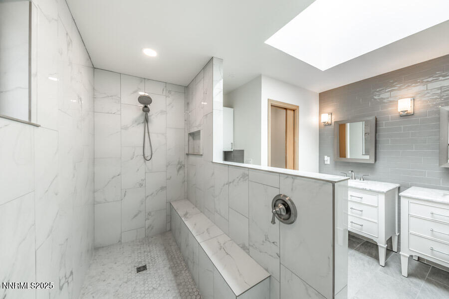 2220 Stone Mountain Circle Reno, NV 89519 - Photo 27 of 58 a bathroom with a shower a sink and a mirror