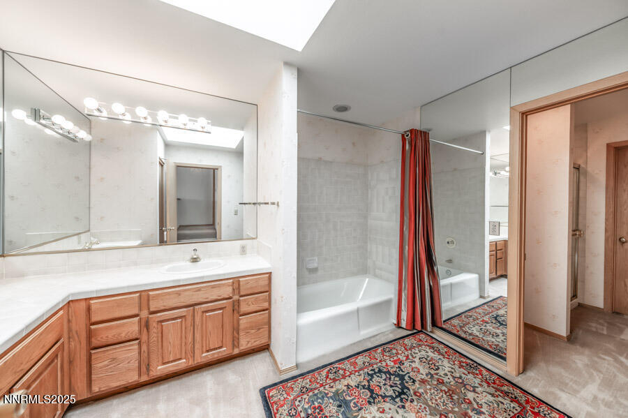 2220 Stone Mountain Circle Reno, NV 89519 - Photo 36 of 58 a spacious bathroom with a double vanity sink a large mirror a shower and bathtub