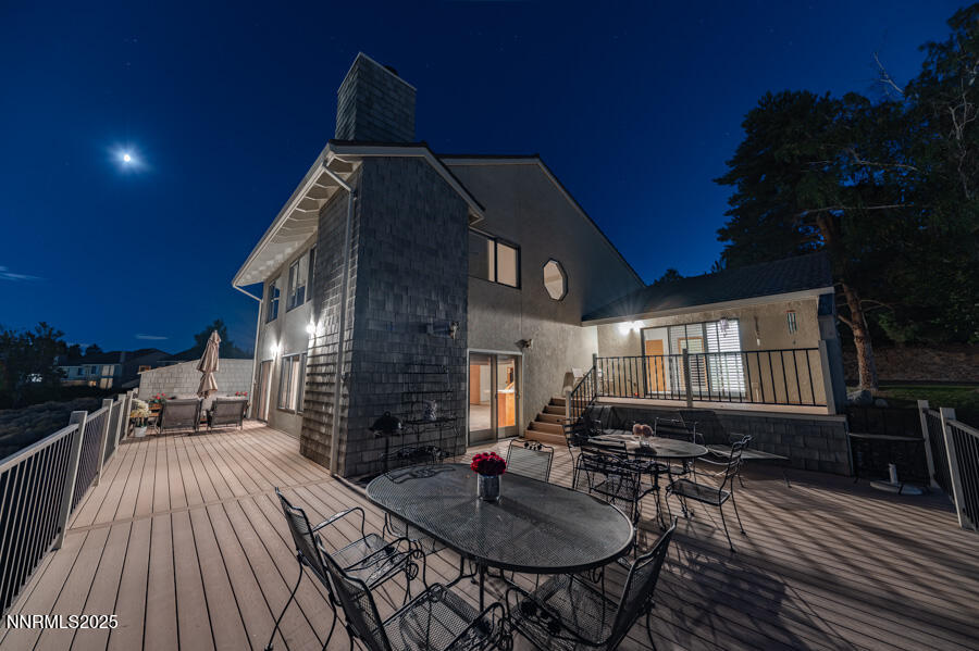 2220 Stone Mountain Circle Reno, NV 89519 - Photo 53 of 58 a roof deck view with table and chairs a barbeque with wooden floor and plants