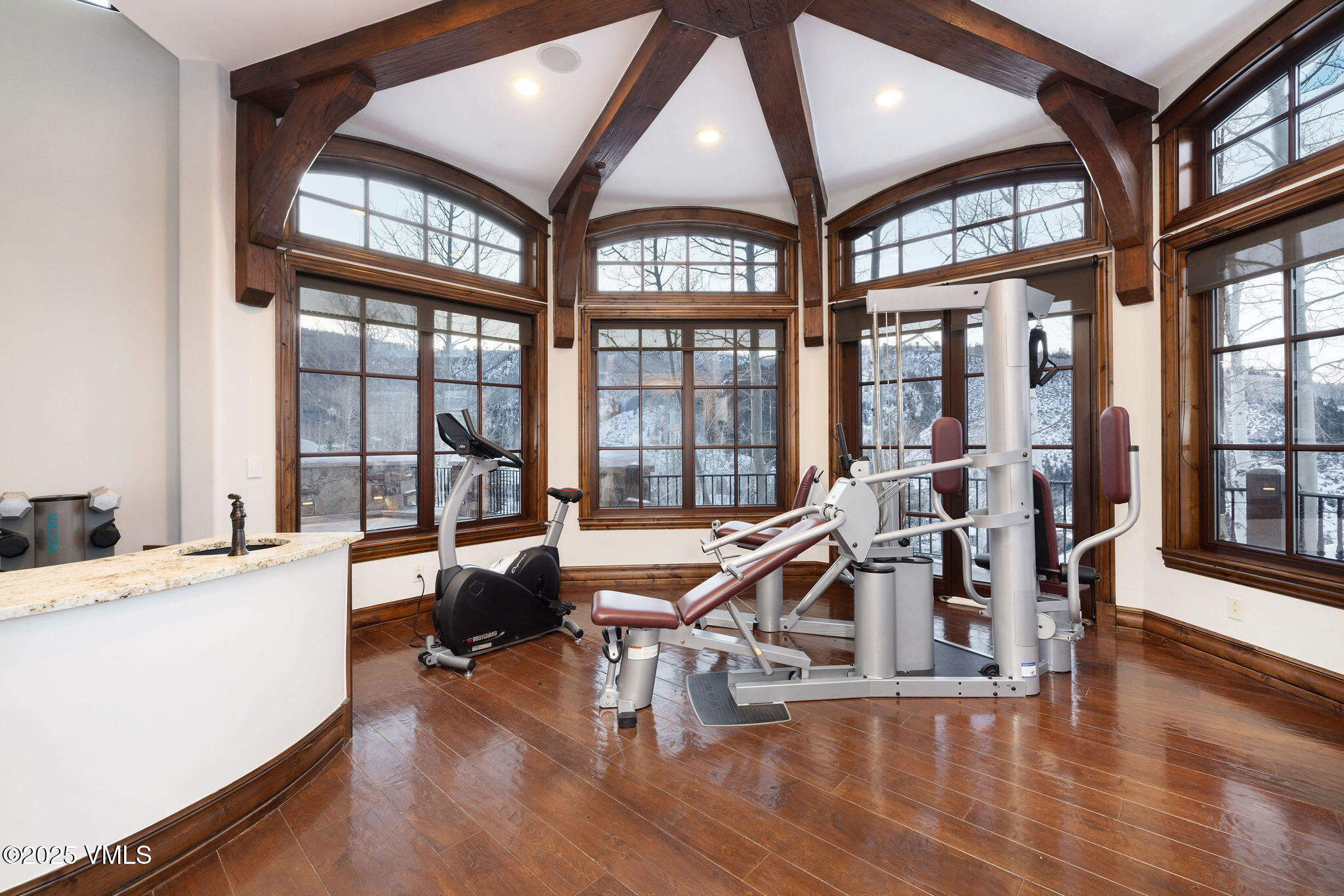 2195 Cresta Road Edwards, CO 81632 - Photo 24 of 43 a view of a livingroom with furniture a floor to ceiling windows and wooden floor