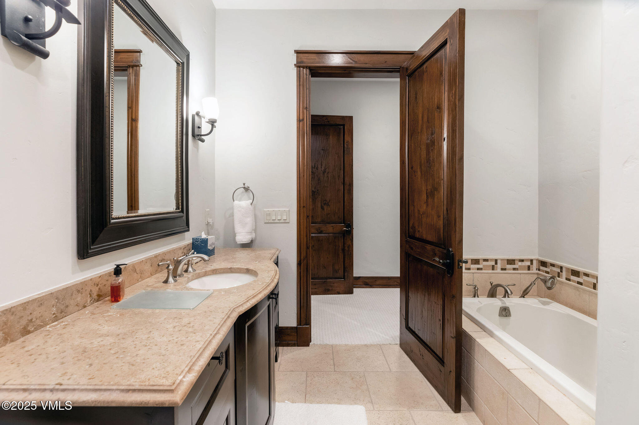 2195 Cresta Road Edwards, CO 81632 - Photo 30 of 43 a bathroom with a granite countertop sink and a bathtub