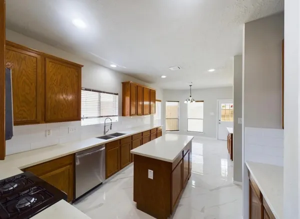 a kitchen with a sink stove and cabinets