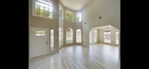 a view of an entryway with wooden floor and windows
