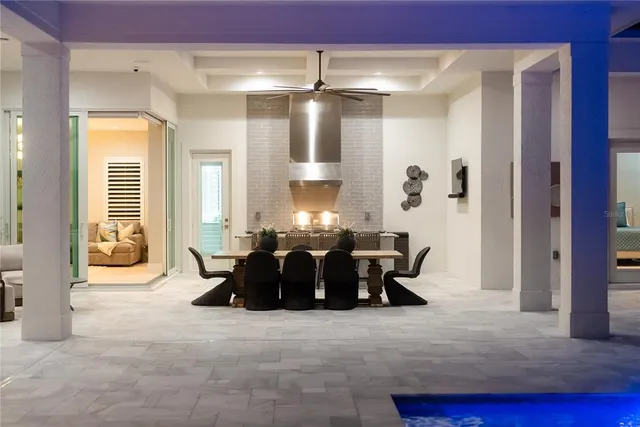 a living room with furniture a flat screen tv and a chandelier