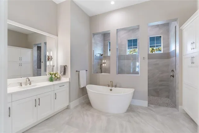 a dining room with kitchen island stainless steel appliances furniture a chandelier and living room view