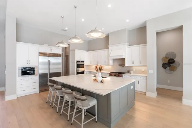 a living room with furniture a flat screen tv and a chandelier