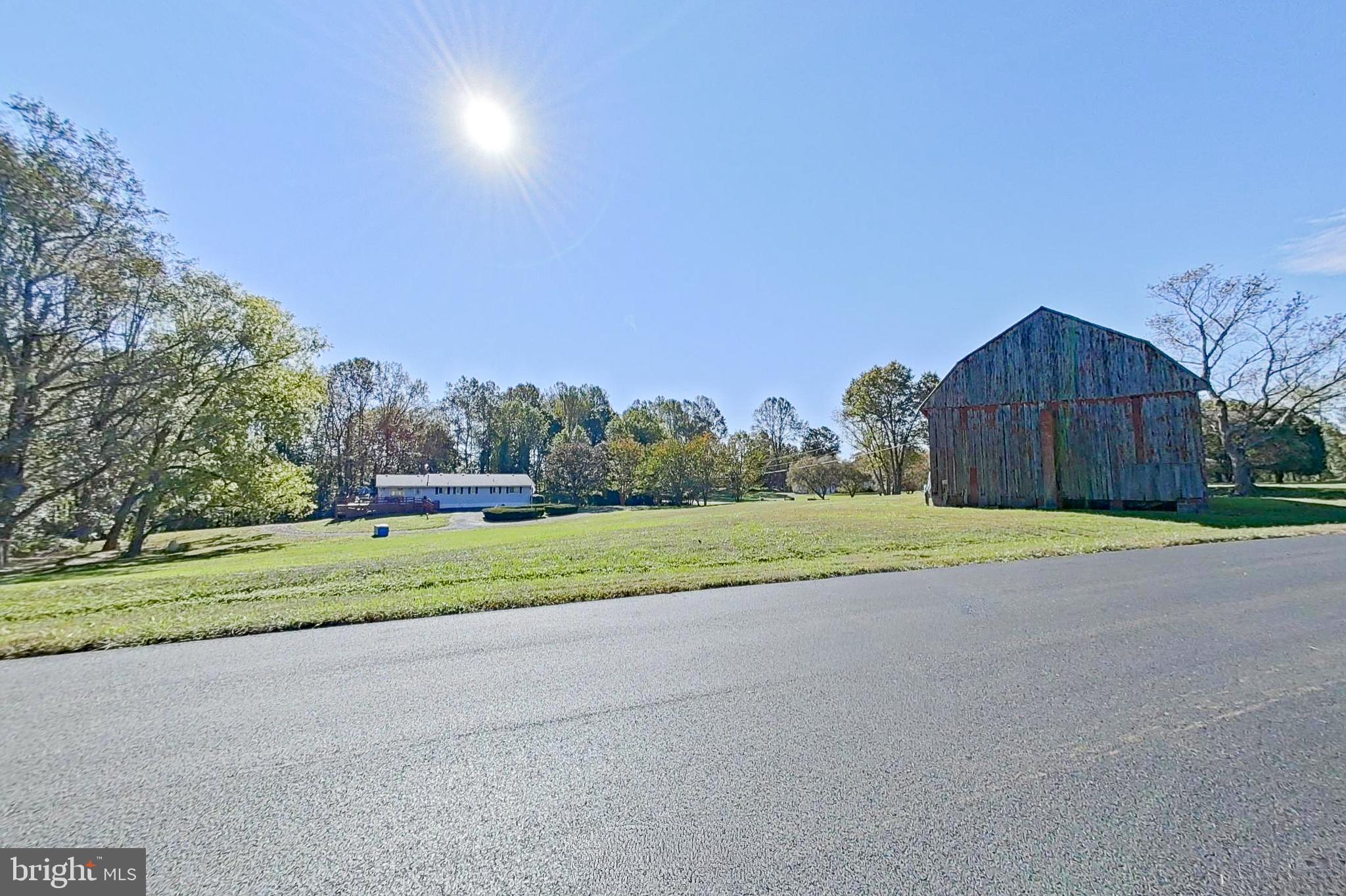 300 Armiger Road Huntingtown, MD 20639 - Photo 39 of 46 a view of an house with a yard and a large parking space
