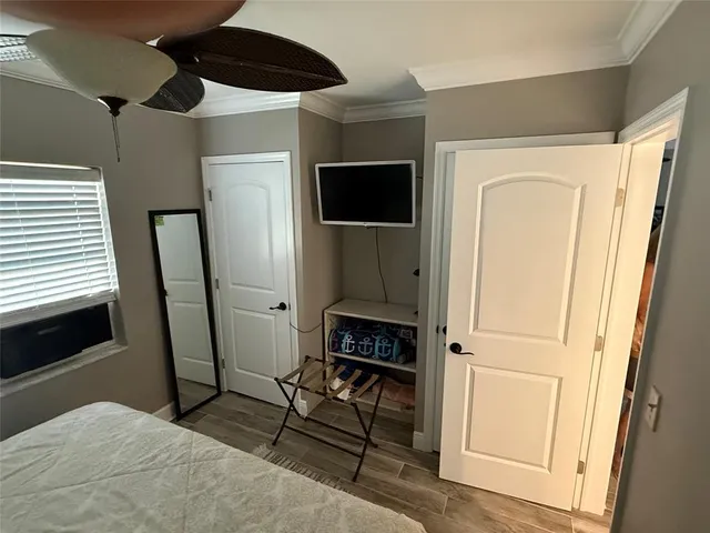 a bedroom with a bed a dresser and a window