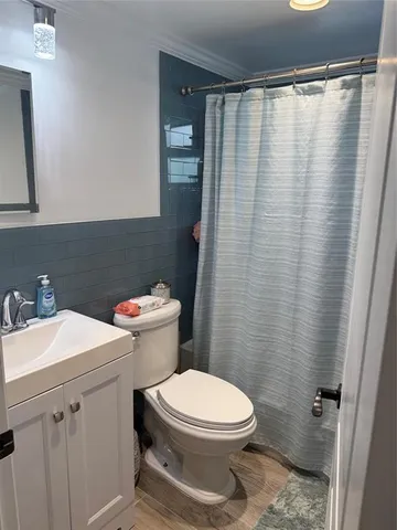 a white toilet sitting next to a bathroom sink