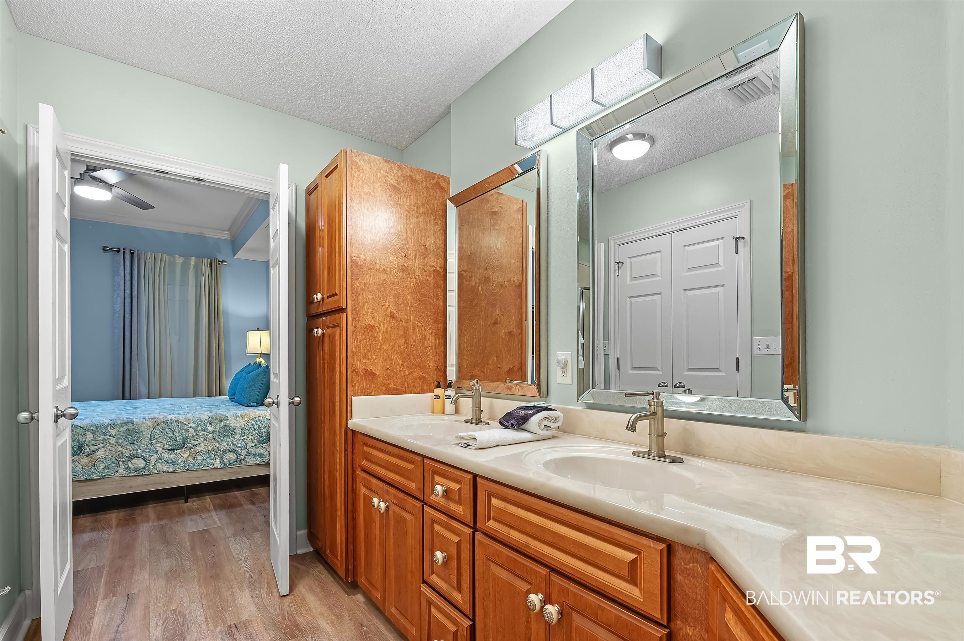 27582 Canal Road, Unit 2104 Orange Beach, AL 36561 - Photo 24 of 35 Bathroom featuring wood-type flooring, double vanities, tub, walk in shower, toilet