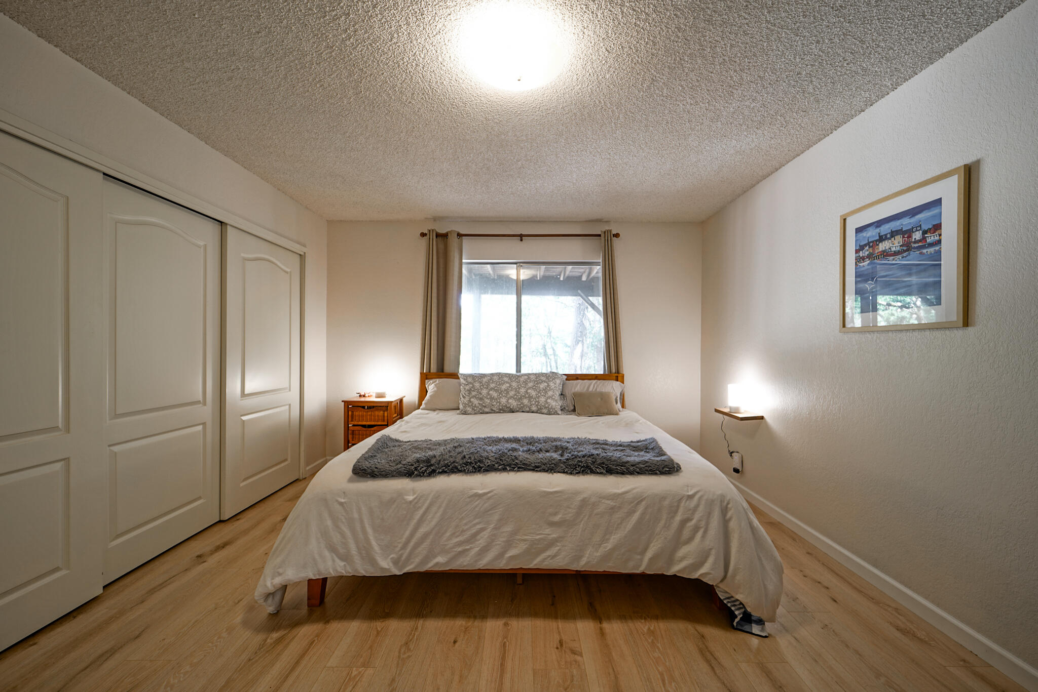500 Timber Ridge Road Weaverville, CA 96093 - Photo 35 of 61 a bedroom with a bed and wooden floor
