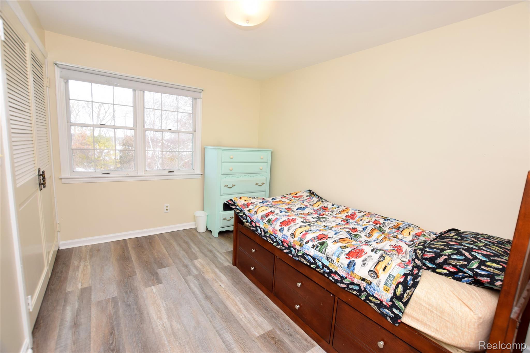 15489 Linden Road Linden, MI 48451 - Photo 14 of 25 Bedroom featuring light wood-style floors and a closet
