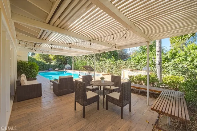 a view of a patio with table and chairs and wooden floor