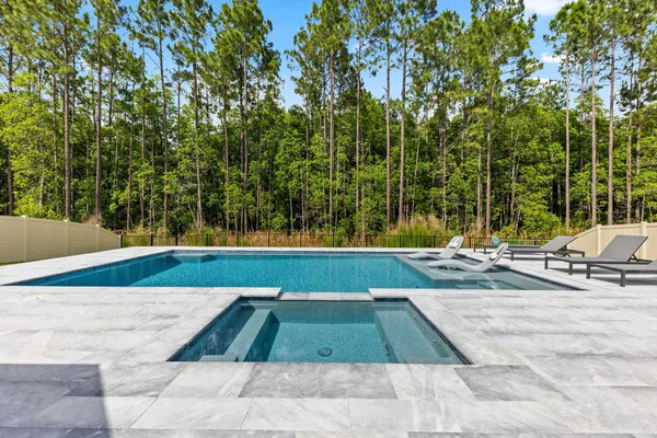 a view of swimming pool with chairs