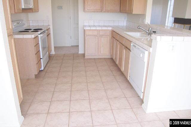 1418 Backer Way Reno, NV 89523 - Photo 7 of 9 a kitchen with a sink a stove top oven and cabinets