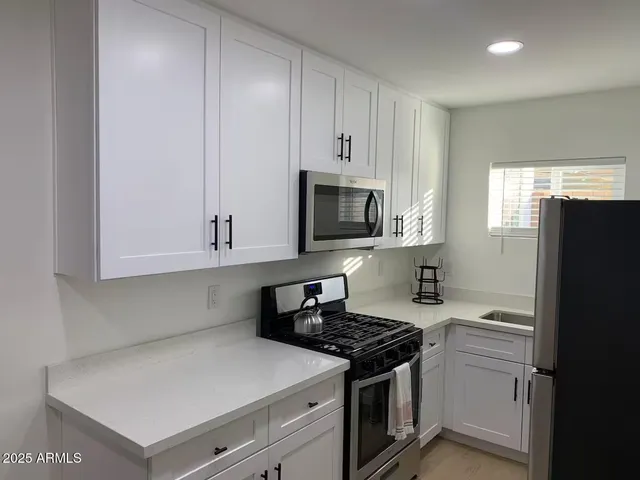 a kitchen with a stove and a refrigerator