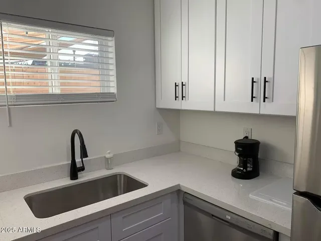 a kitchen with a sink a stove and refrigerator