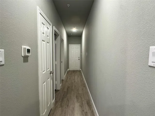 a view of hallway with wooden floor