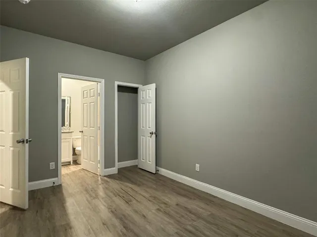 an empty room with wooden floor
