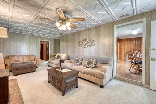 a living room with furniture and a chandelier