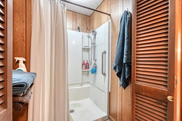 a bathroom with a shower and a sink