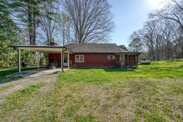 a view of a house with yard and tree s