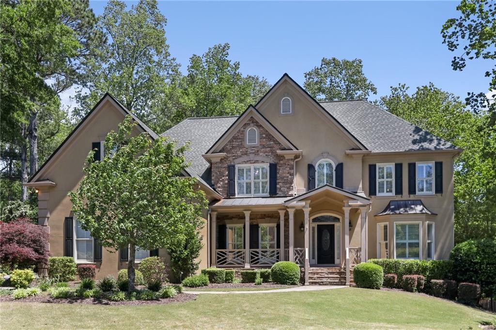 a front view of a house with garden