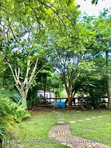 2762 F Road Loxahatchee, FL 33470 - Photo 15 of 25 a view of a backyard with large trees