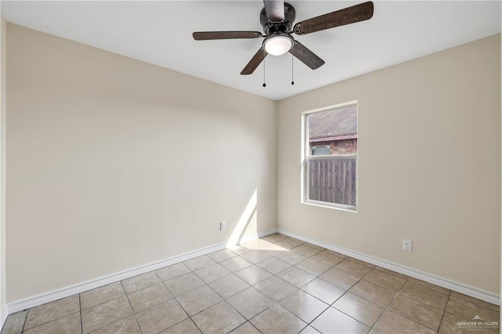 709 Alexandra Avenue Mercedes, TX 78570 - Photo 11 of 16 an empty room with windows and fan