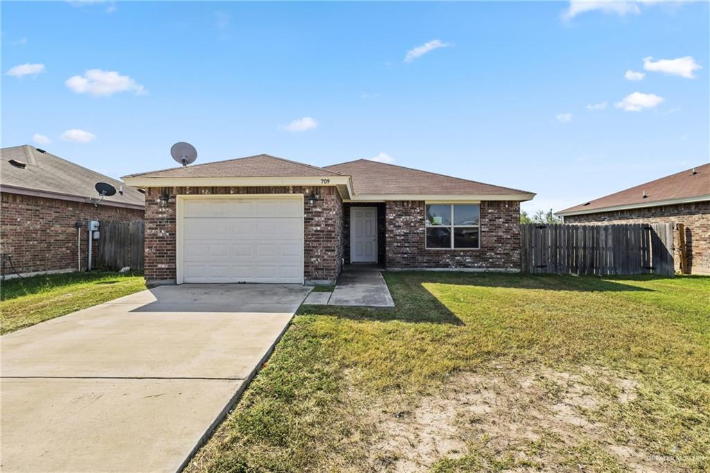 709 Alexandra Avenue Mercedes, TX 78570 - Photo 2 of 16 a front view of a house with a yard