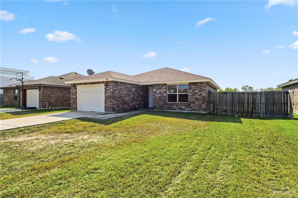 709 Alexandra Avenue Mercedes, TX 78570 - Photo 3 of 16 a front view of a house with a yard
