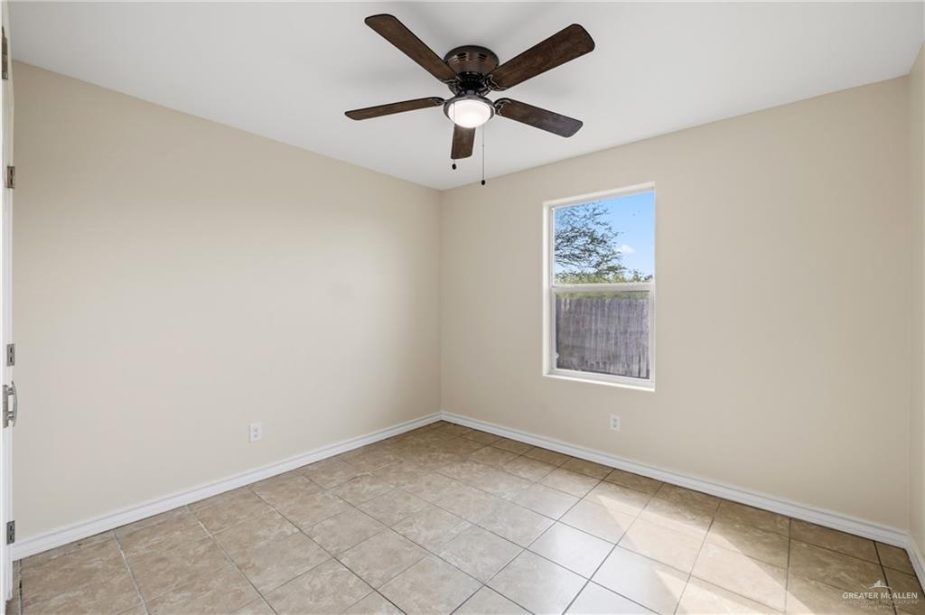 709 Alexandra Avenue Mercedes, TX 78570 - Photo 9 of 16 an empty room with a window and a fan