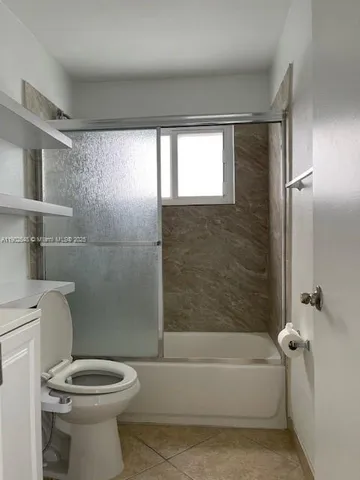 a bathroom with a toilet a sink and bathtub