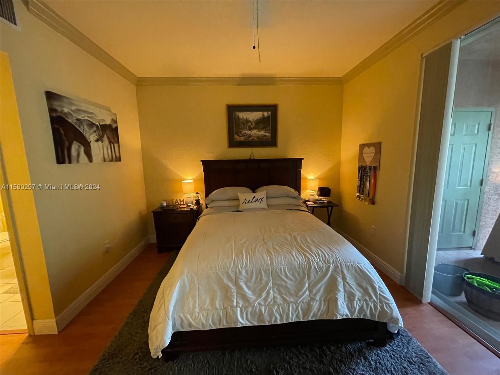 6830 West Sample Road, Unit 6830 Coral Springs, FL 33067 - Photo 11 of 30 a bed sitting in a bedroom next to a window