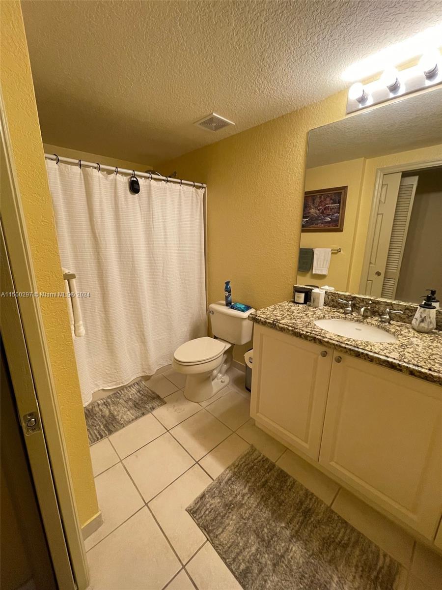 6830 West Sample Road, Unit 6830 Coral Springs, FL 33067 - Photo 15 of 30 a bathroom with a granite countertop sink and a mirror