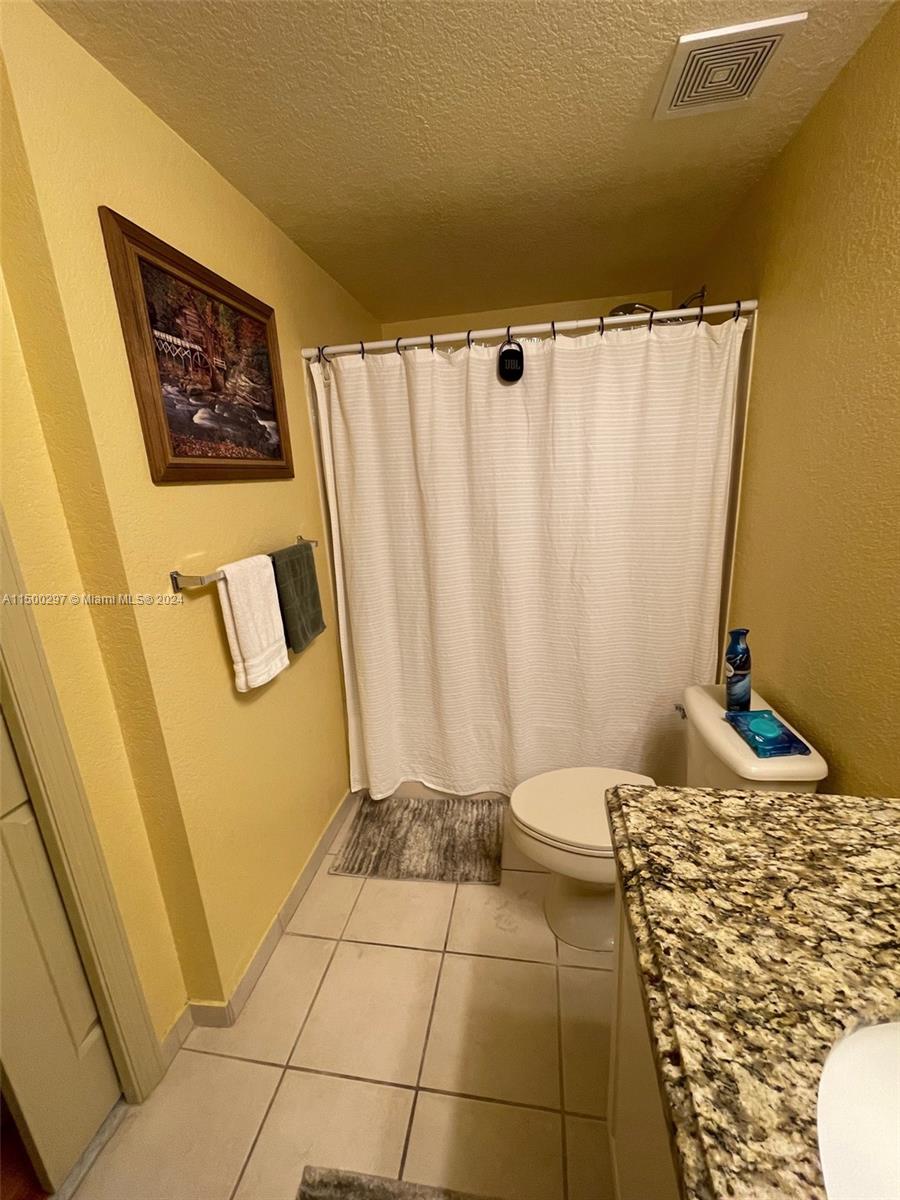 6830 West Sample Road, Unit 6830 Coral Springs, FL 33067 - Photo 16 of 30 a view of a bathroom with a sink and a shower