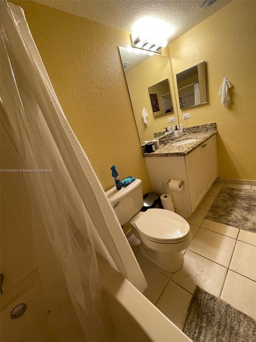 6830 West Sample Road, Unit 6830 Coral Springs, FL 33067 - Photo 18 of 30 a white toilet sitting next to a bathroom sink
