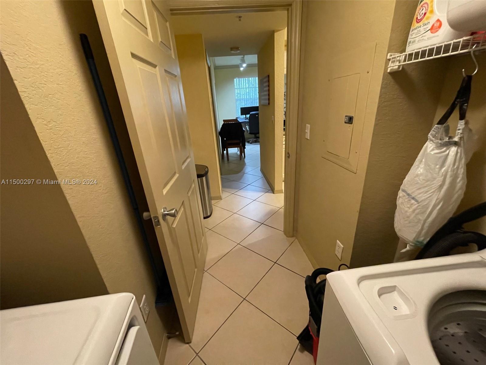 6830 West Sample Road, Unit 6830 Coral Springs, FL 33067 - Photo 20 of 30 a view of a hallway with washer and dryer