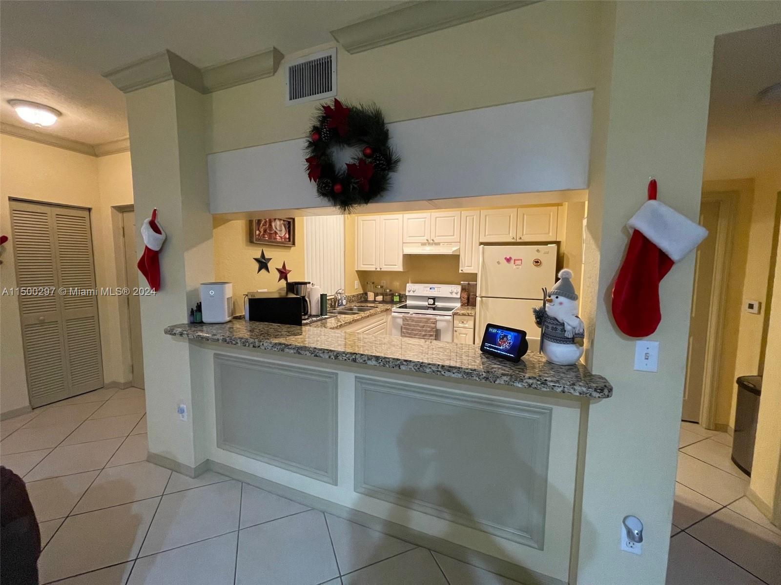 6830 West Sample Road, Unit 6830 Coral Springs, FL 33067 - Photo 8 of 30 a kitchen with stainless steel appliances kitchen island granite countertop a sink and a cabinets