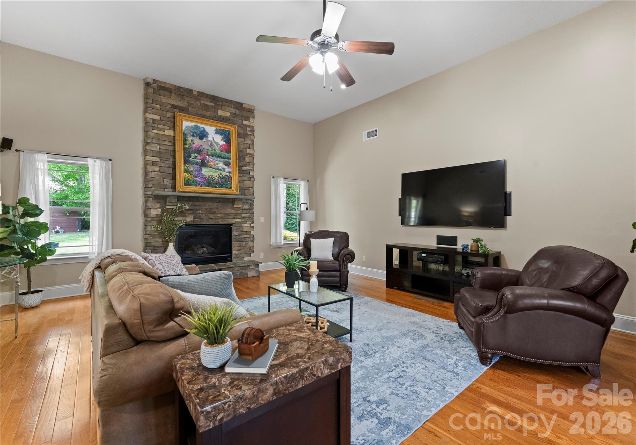 860 Arrow Point Lane Kannapolis, NC 28081 - Photo 11 of 38 a living room with furniture a flat screen tv and a fireplace