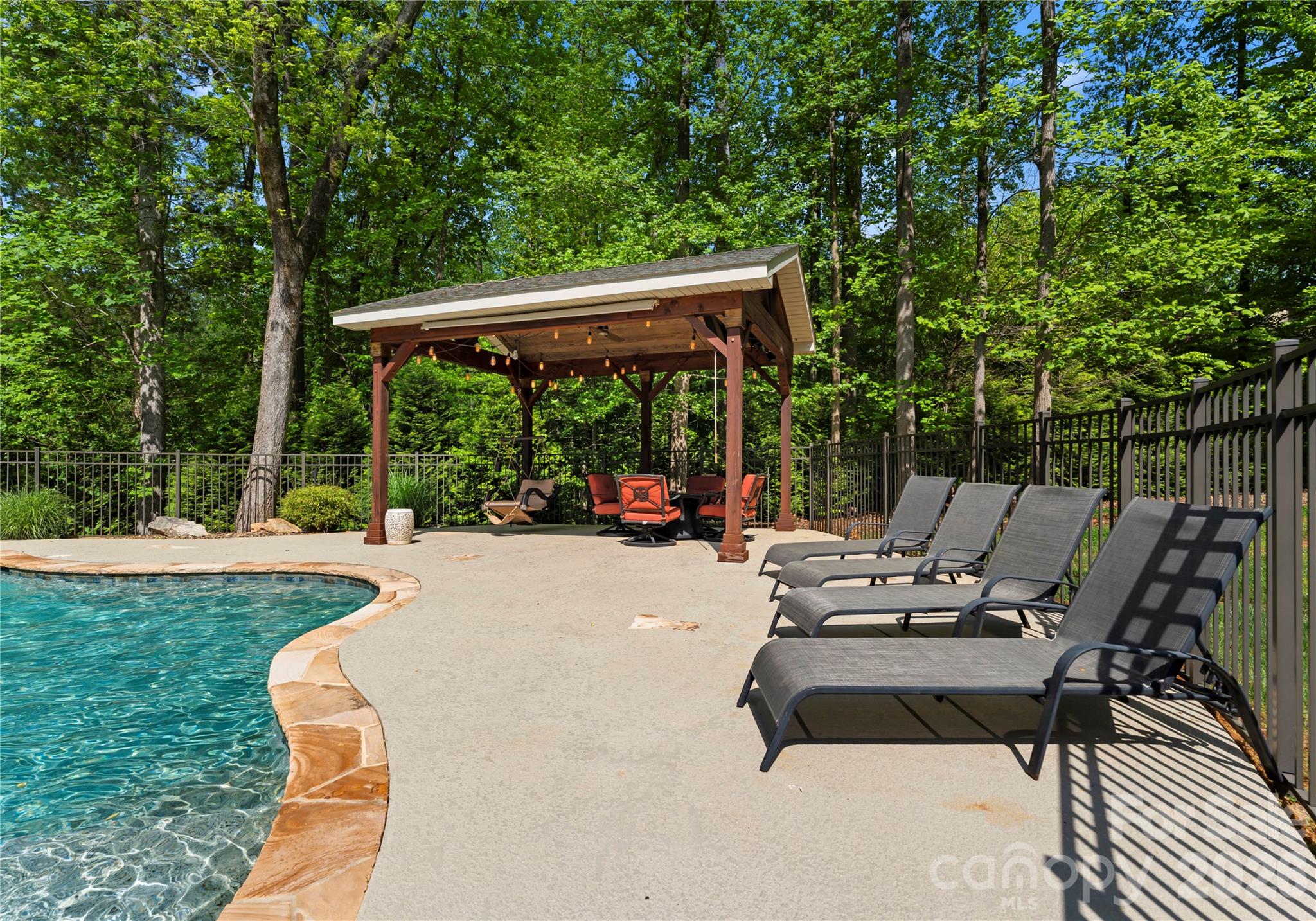 860 Arrow Point Lane Kannapolis, NC 28081 - Photo 31 of 38 a view of backyard of a house with table and chairs