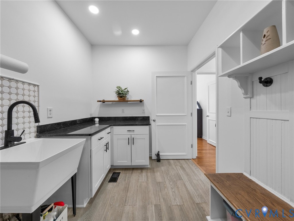 6126 Autumn Bluff Road Powhatan, VA 23139 - Photo 25 of 47 a kitchen with granite countertop a sink stainless steel appliances and white cabinets